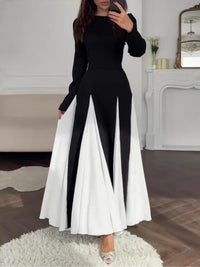 Vestido elegante negro y blanco con cuello redondo y mangas largas